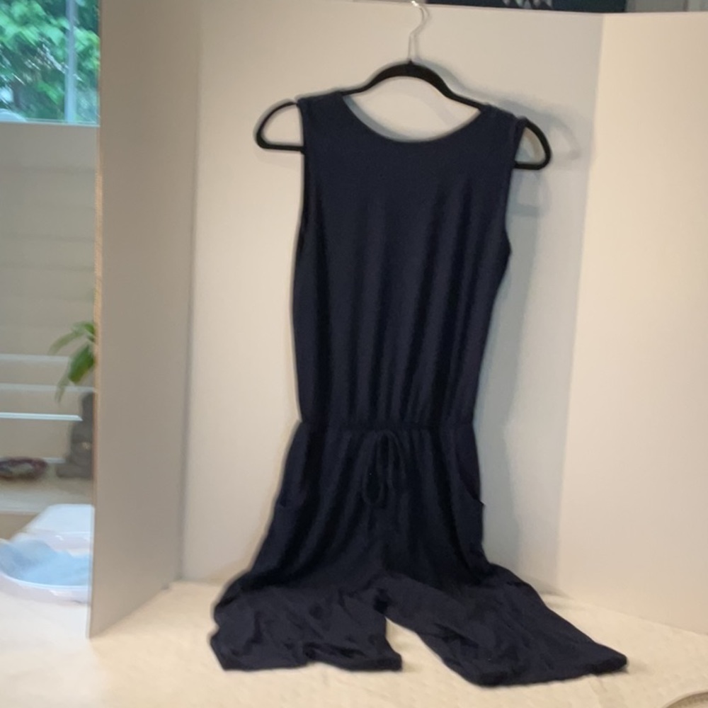 Navy Jumpsuit with pockets and fixed elastic.